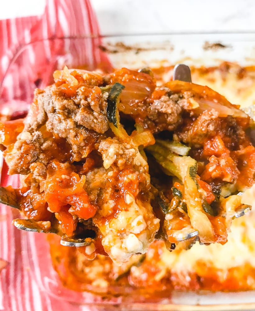 Close up of scoop of baked zucchini pasta.