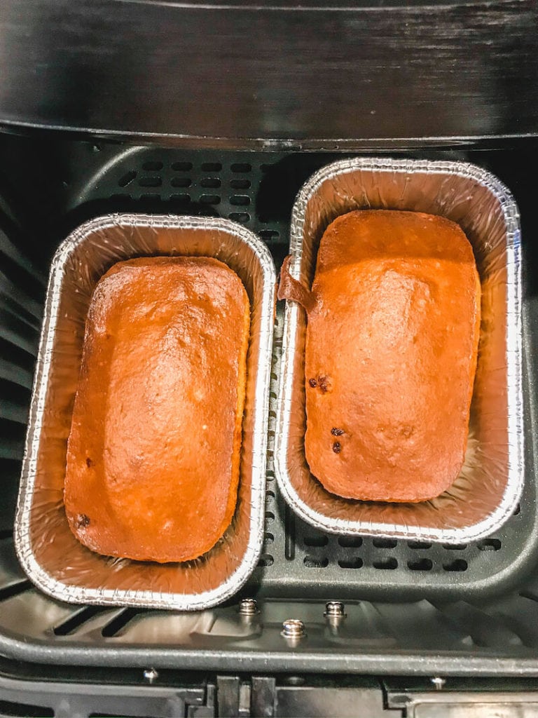 Two cooked loaves of banana bread inside Ari fryer basket.