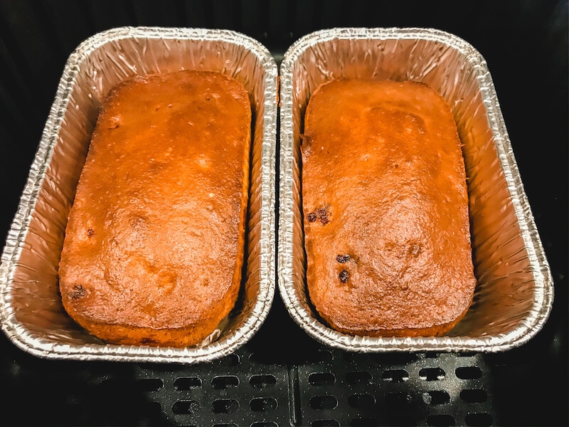 Two small loaves of banana bread in foil pans.