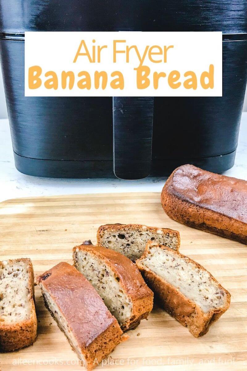 A loaf of banana bread next to slices of banana bread, all in front of black air fryer.
