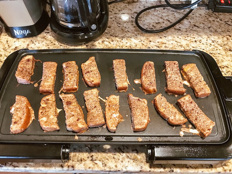 French toast sticks on a large griddle.