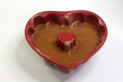Heart shaped cake pan filled with chocolate cake batter