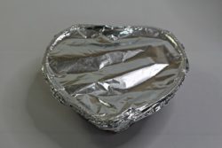 Heart shaped pan covered with foil.