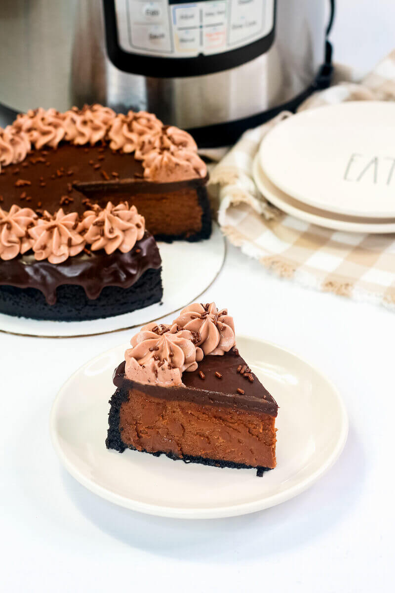 A slice of nutella cheesecake next to a plate of chocolate cheesecake.