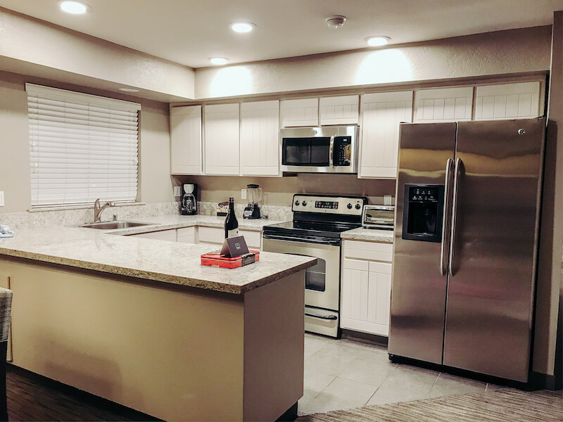 A full sized modern kitchen with stainless steel appliances. 