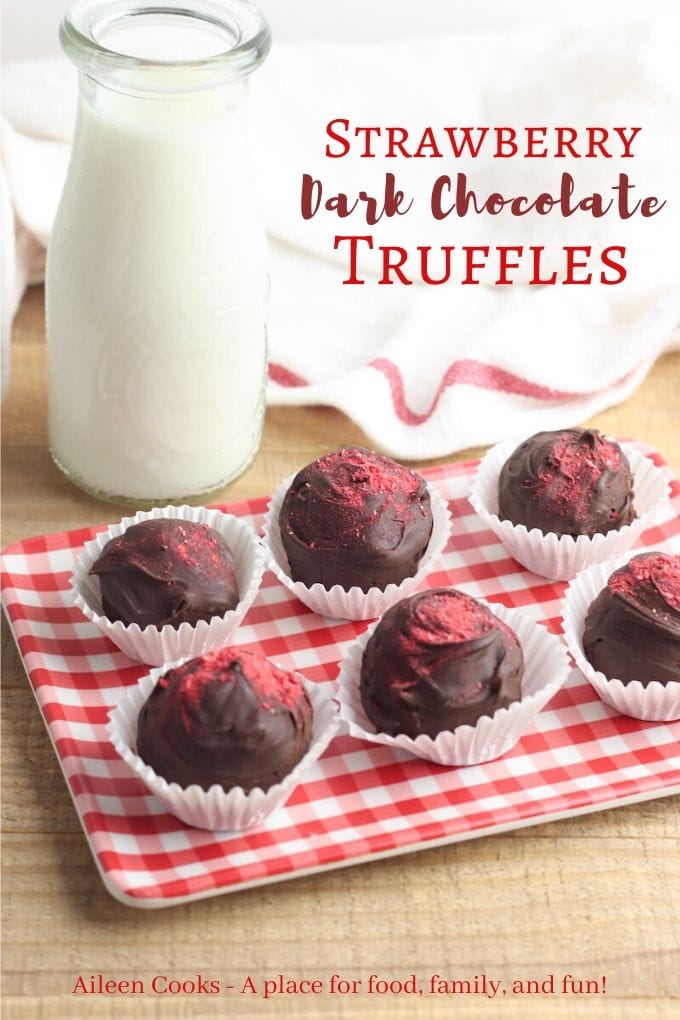 A platter of dark chocolate truffles dusted in strawberry powder and the words "strawberry dark chocolate truffles" in red letters.