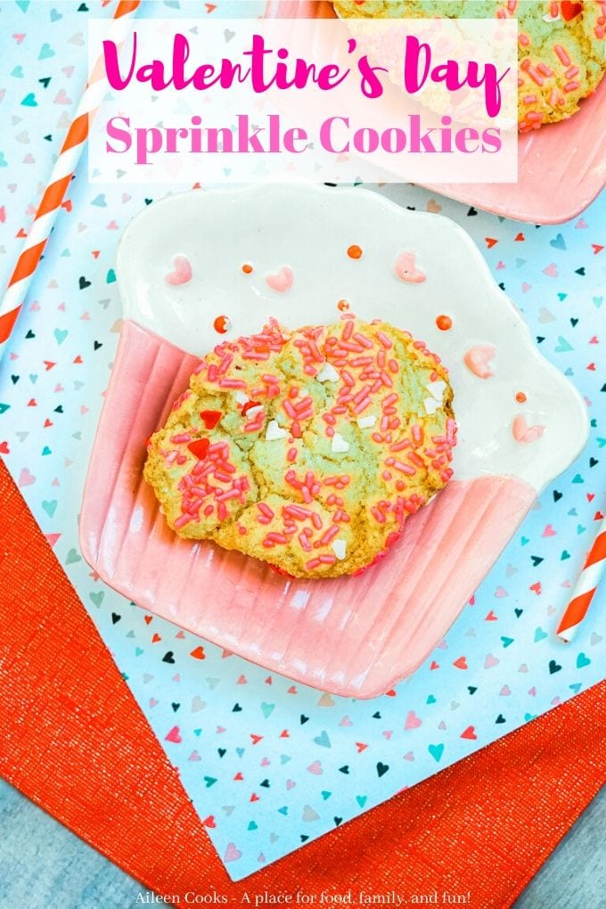 A pink and white plate with a sprinkle cookie on it and the words "valeintine's day sprinkle cookies" in pink.