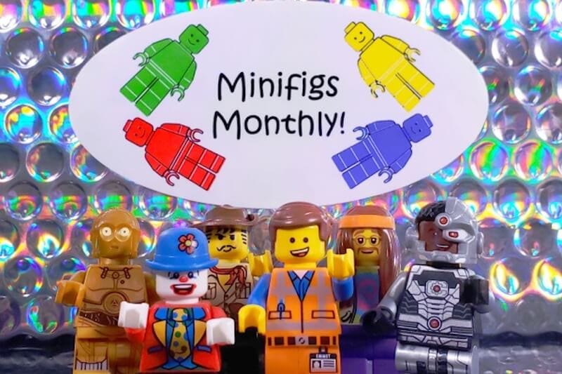 Several LEGO figurines with a sign that says "minifigs monthly".