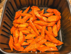 Fresh carrots inside of air fryer.