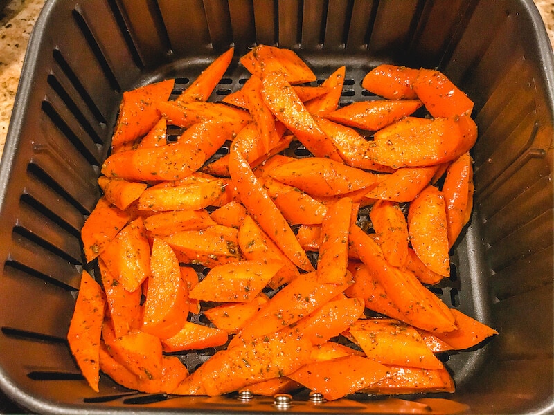 Fresh carrots inside of air fryer.