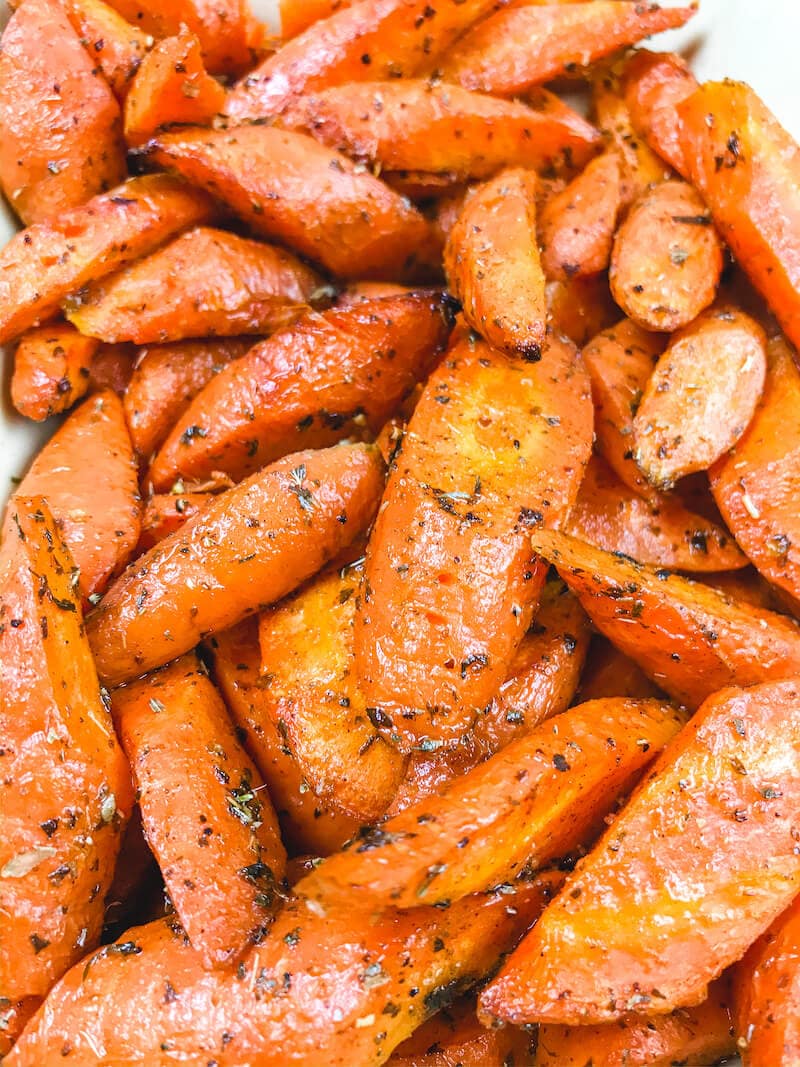 Close up of air fried carrots covered in herbs.