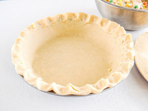 A pie crust inside of a pie dish.