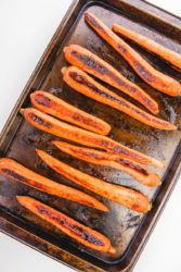 Roasted carrots on a cookie sheet.