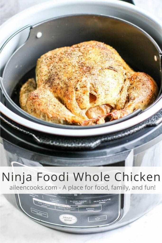 A whole chicken with crispy skin inside a Ninja Food with the words "Ninja Foodi Whole Chicken" in black letters.