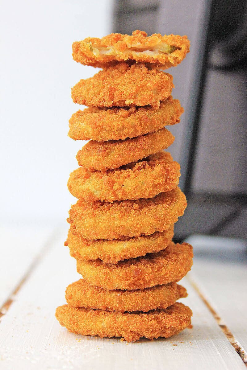 A stack of fried pickles on a white counter.