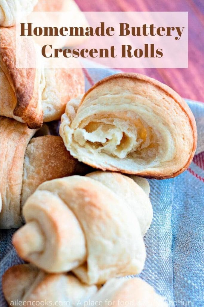 Close up of crescent roll cut in half with words "homemade buttery crescent rolls" in red lettering.
