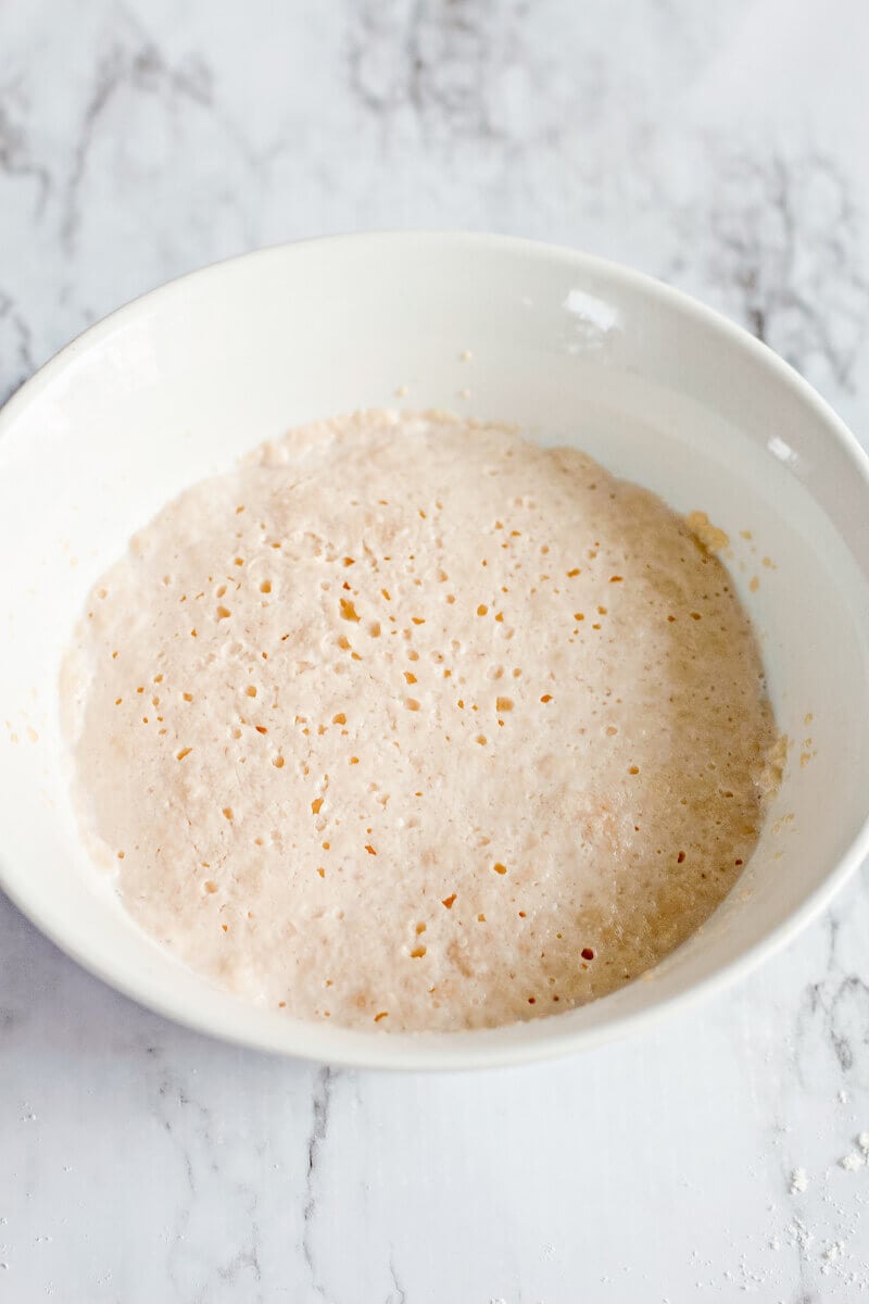 A bowl of activated yeast with milk.