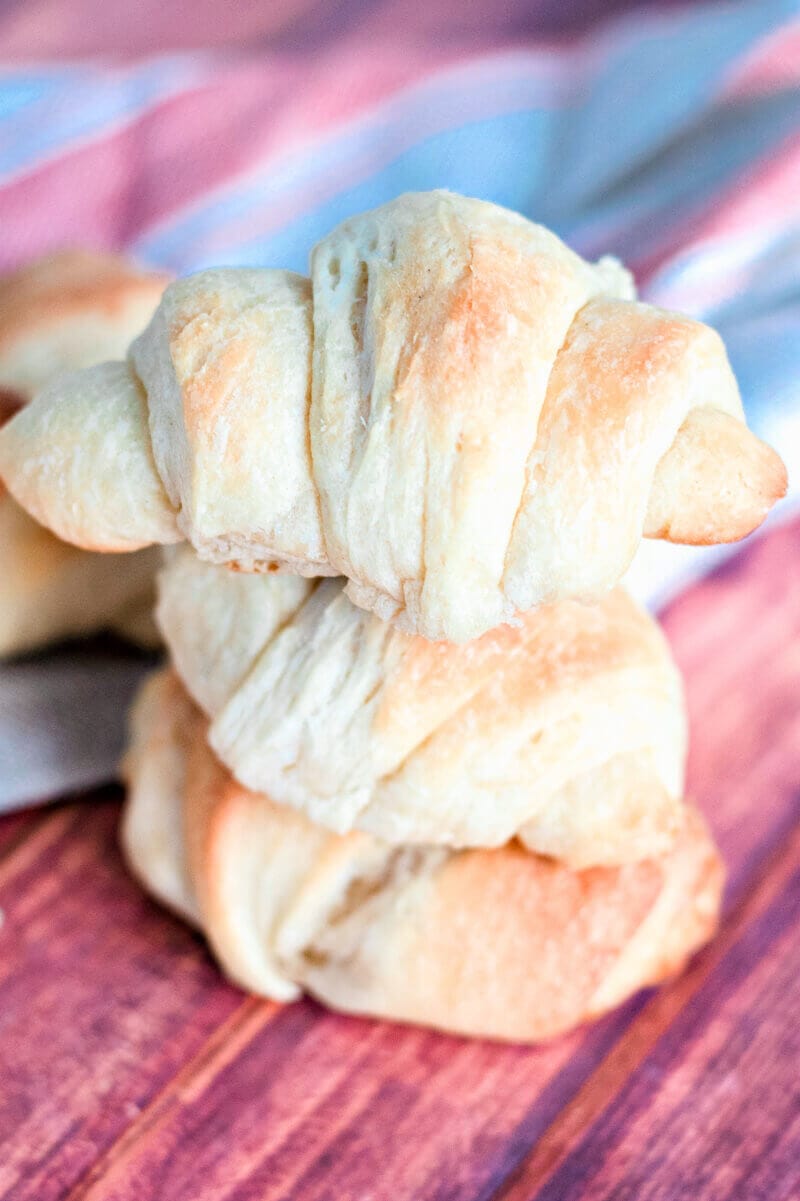 Three crescent rolls stacked on top of each other.