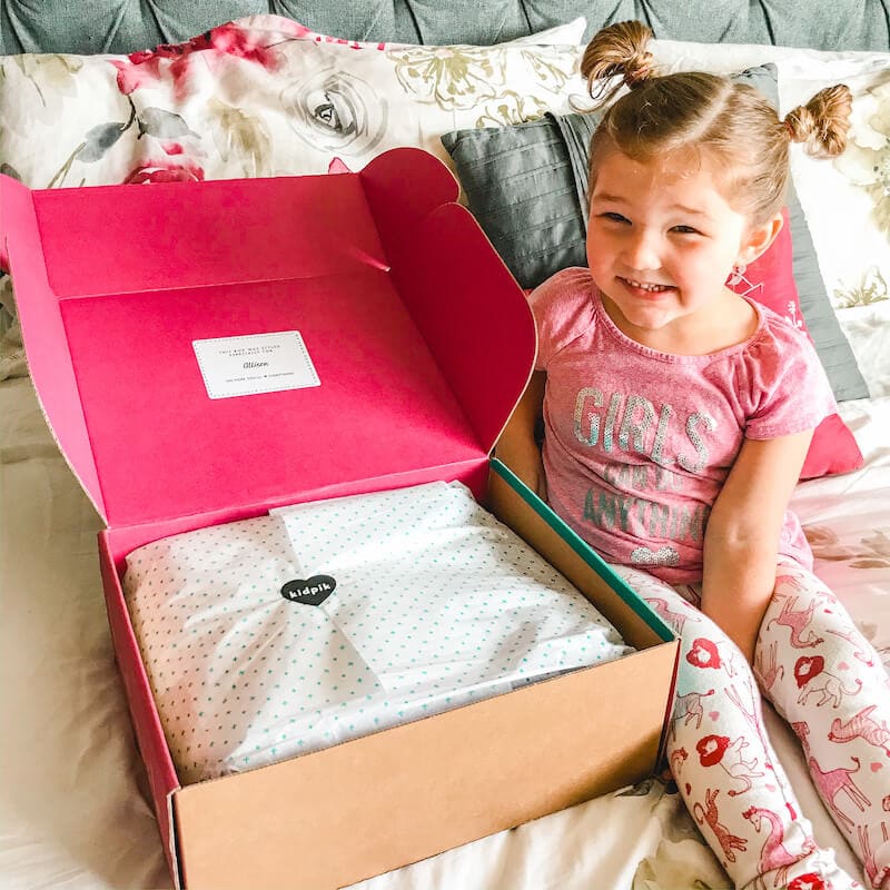 A little girl ready to open her KidPik Box.