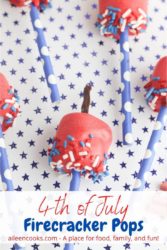 Close up of marshmallow pops on a blue polka dot background with the words "4th of July Firecracker Pops" in blue and red lettering.