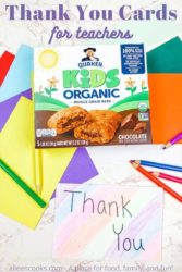 A box of Quaker Kids Organic Bars on top of colorful envelopes and next to a hand colored card that says Thank You.