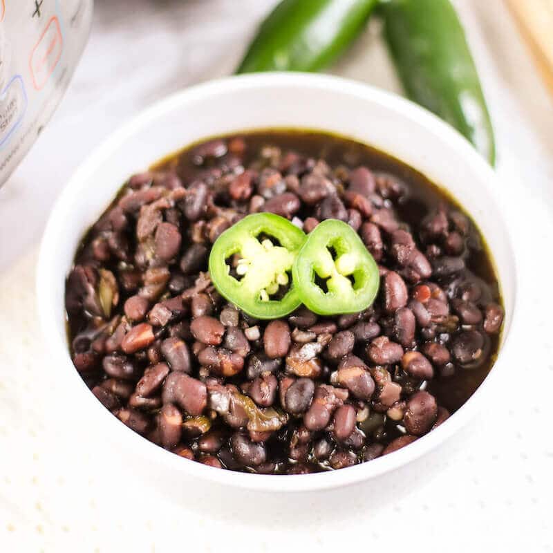 Overhead shot of cuban black beans in a white bowl.