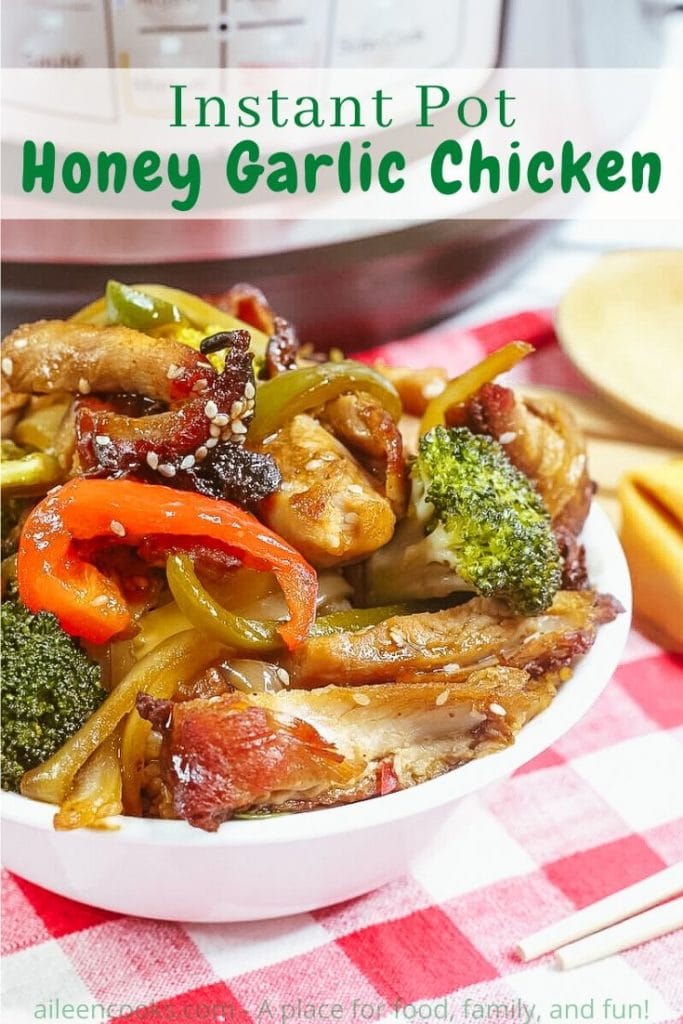 A white bowl piled high with honey garlic chicken with the words "instant pot honey garlic chicken" in green lettering.