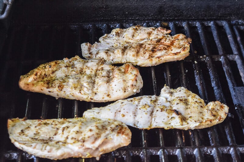 Chicken being grilled on a grill.