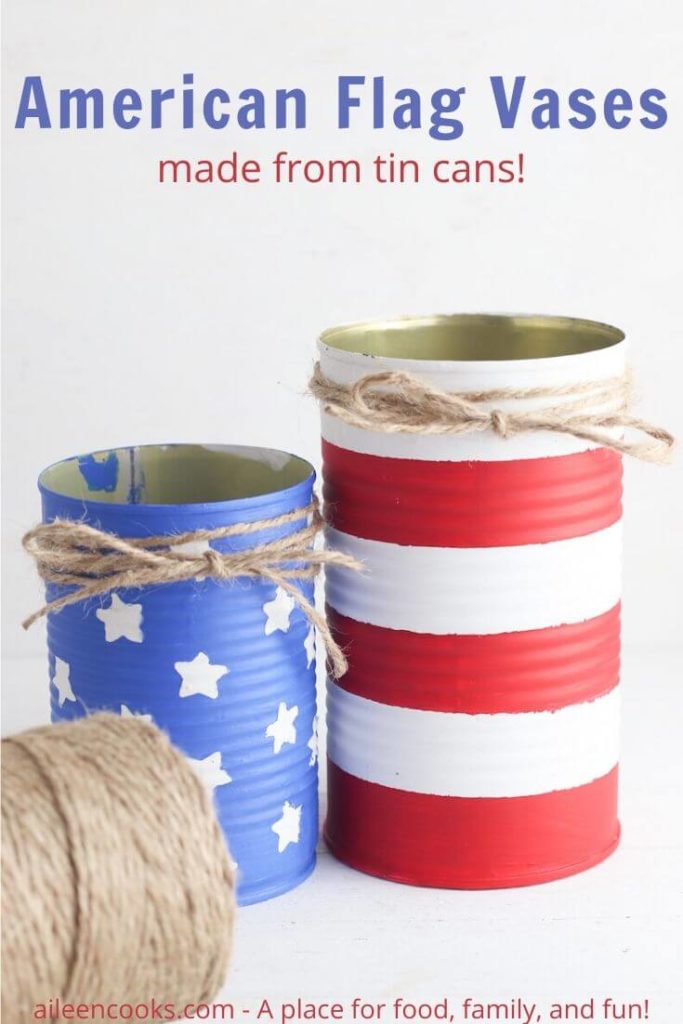 Two tin cans painted to look like the American flag with the words "American flag vases" in blue letters.