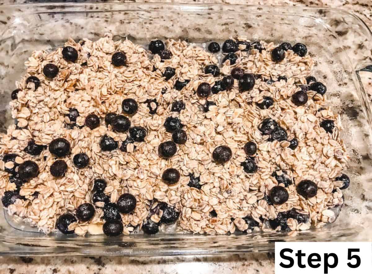 A glass baking dish filled with rolled oats and blueberries. 