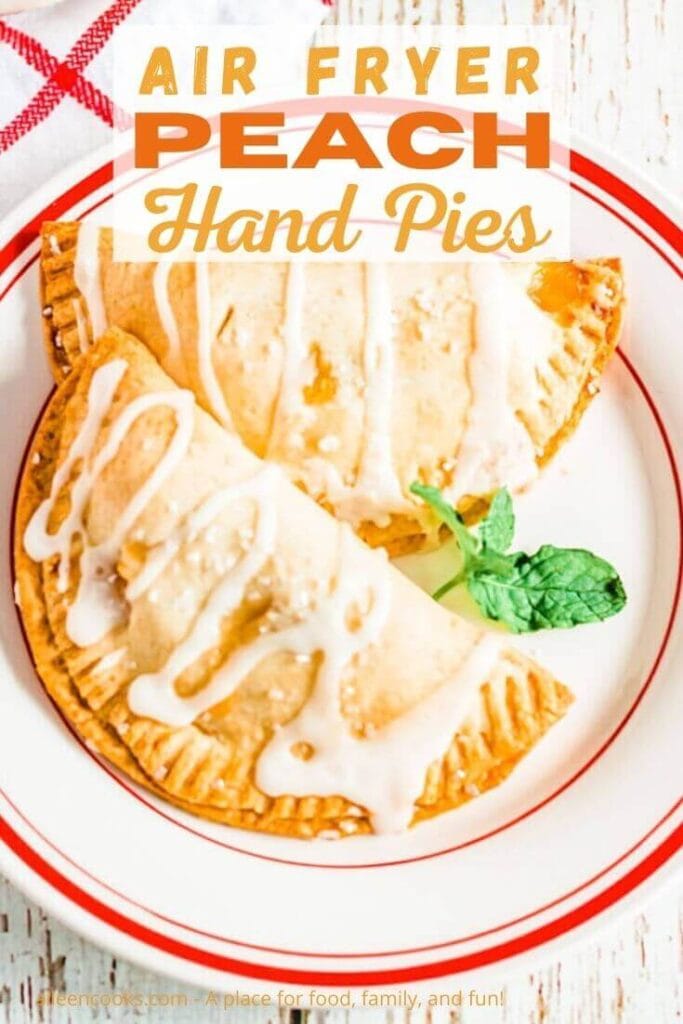 A white plate with two hand pies with the words "air fryer peach hand pies" in orange lettering.