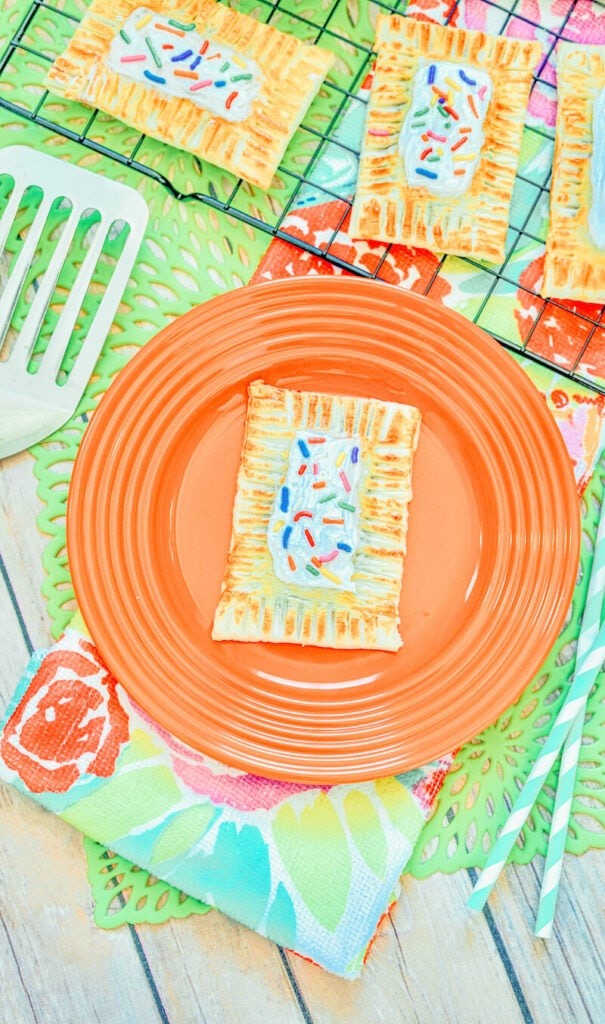 An orange plate with a homemade pop tart on it.