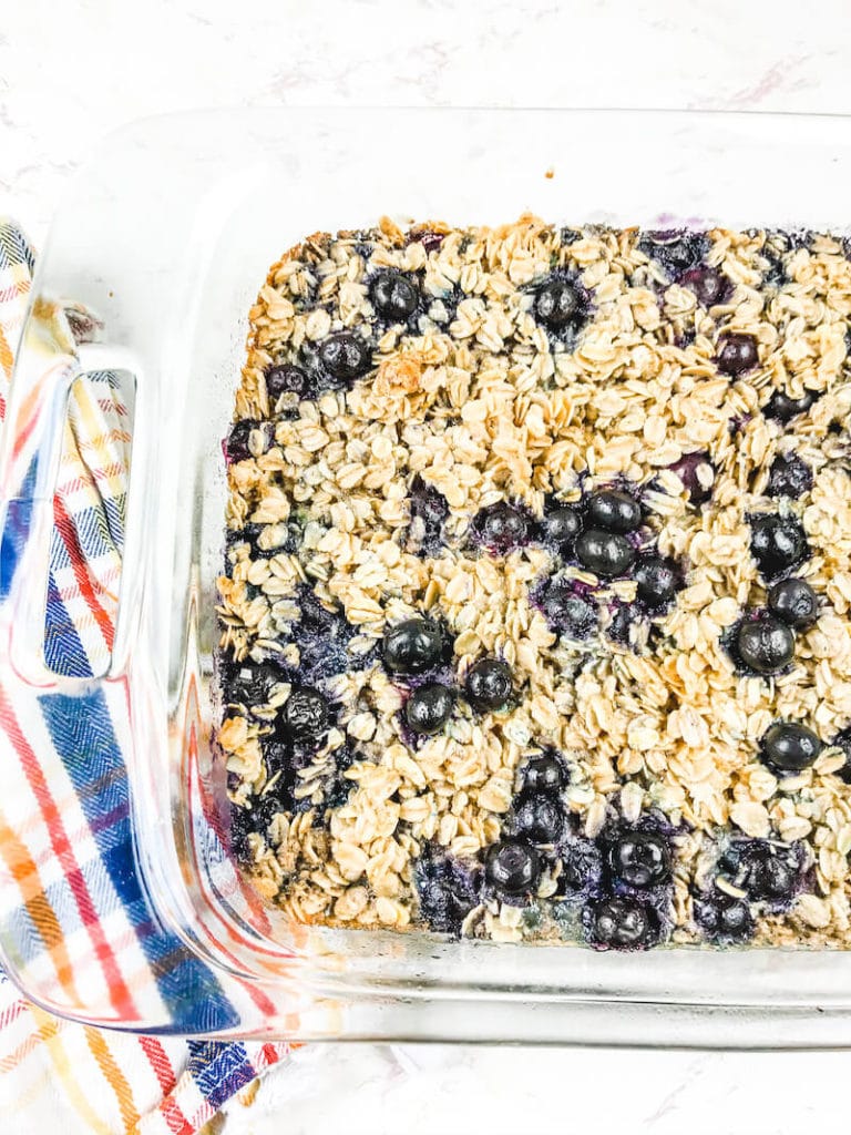 Partial view of a glass baking dish filled with blueberry baked oatmeal.