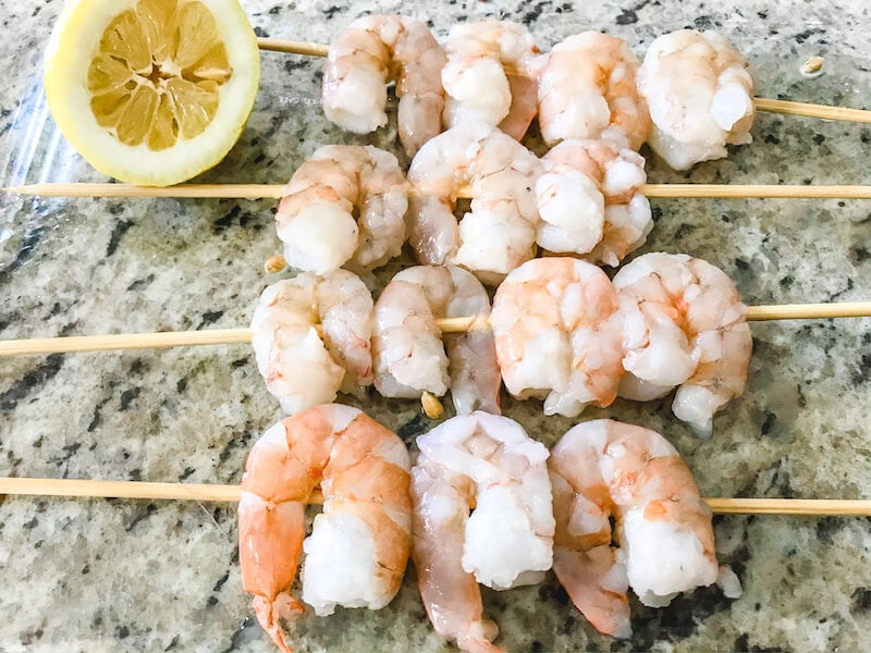 Raw shrimp on skewers.