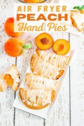 Overhead shot of a hand pies on a white platter with the words "air fryer peach hand pies" in orange lettering.