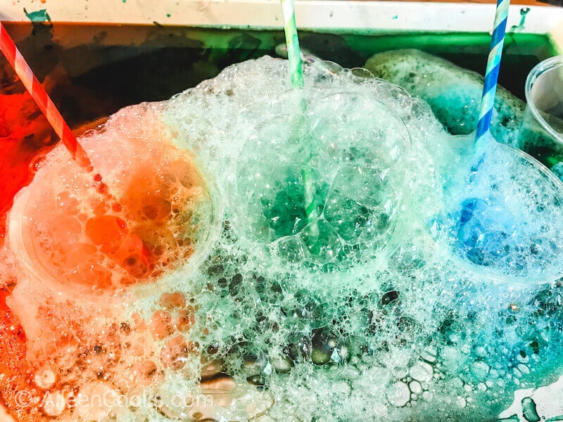 There cups of colorful, bubbly water.