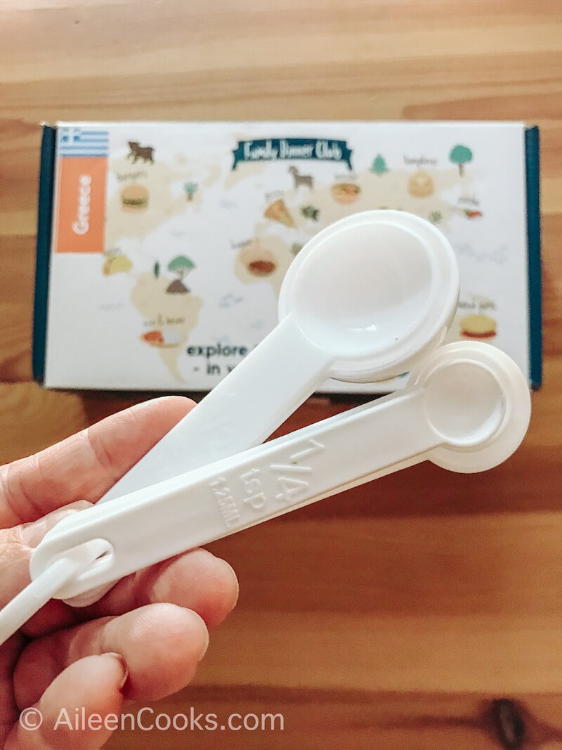 A set of white plastic measuring spoons.