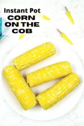 Overhead shot of corn on the cob on a white plate with the words "instant pot corn on the cob'" in black letters.