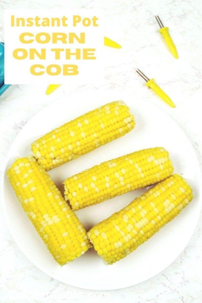 Overhead shot of corn on the cob on a white plate with the words "instant pot corn on the cob'" in yellow letters.