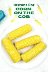 Overhead shot of corn on the cob on a white plate with the words "instant pot corn on the cob'" in green letters.