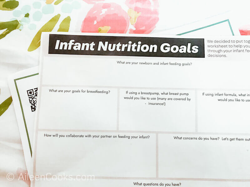 A piece of paper that says Infant Nutrition Goals sitting on top of a floral background.