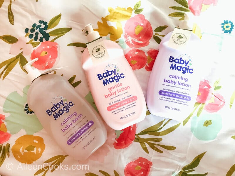 Three bottles of baby magic on a floral background.