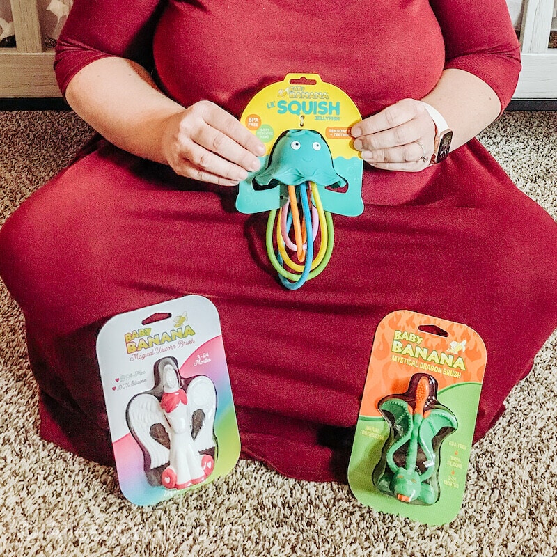 Three Baby Banana toys popped in front of a woman's legs.