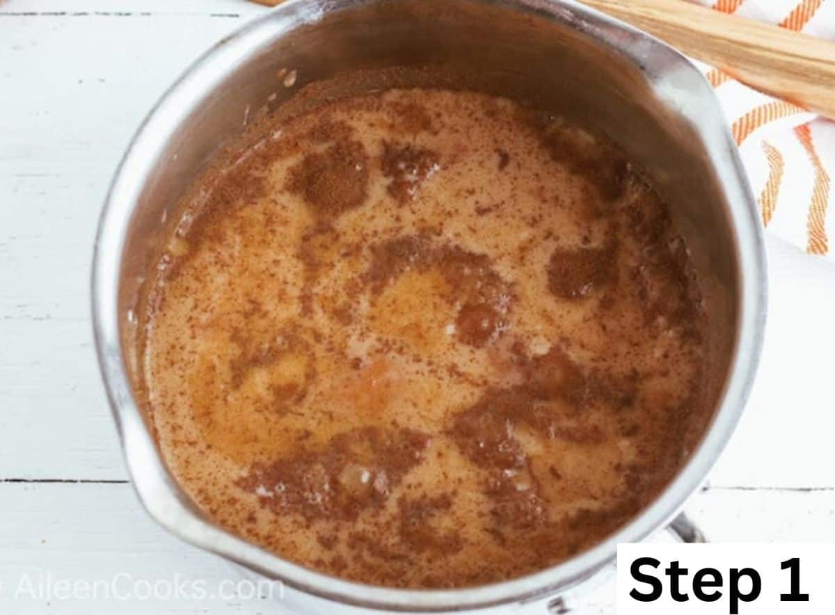 A pot of pumpkin spice latte boiling in a metal pot.