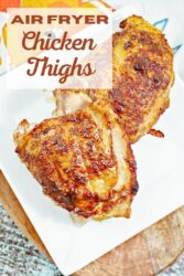 Overhead shot of chicken thighs on a white platter with words "air fryer chicken thighs" in brown lettering".