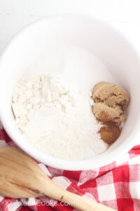 Sugar and flour in a white bowl.