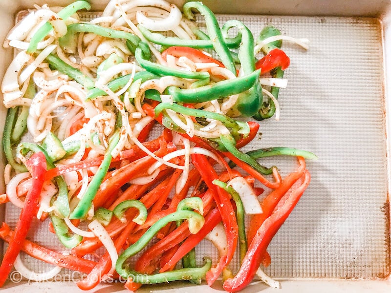 Bell peppers and onions on a cookie sheet.
