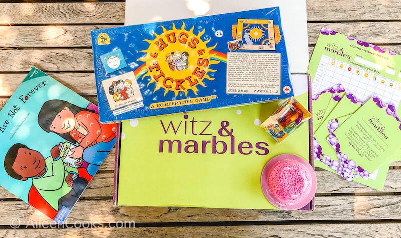 A green box with the words "Witz & Marbles" along with the activities included in the box.