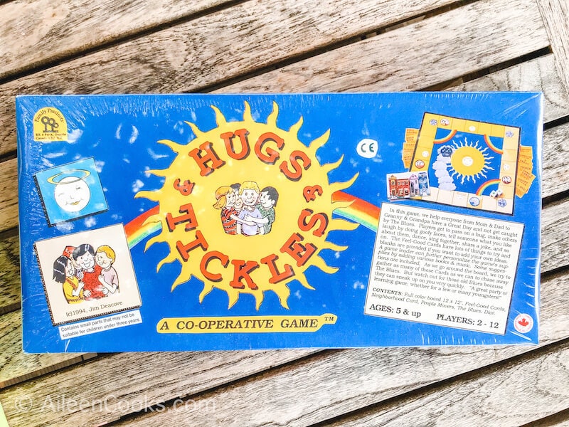 A blue board game with the words "hugs & tickles"