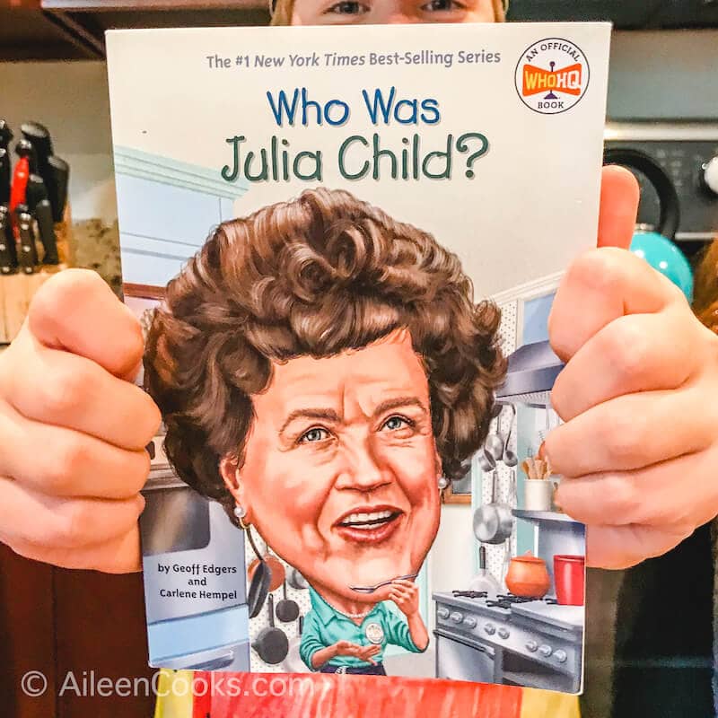 Two hands holding up The Who Was Julia Child? book.